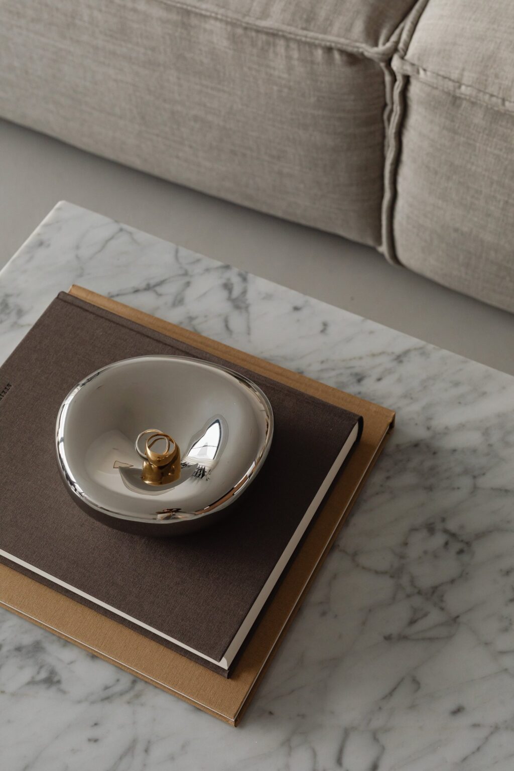 kaboompics_living-room-gray-beige-sofa-marble-coffee-table-coffee-table-books-candle-29378